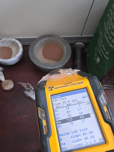 Un outil de mesure électronique jaune posé sur une table avec diverses mesures à l'écran.